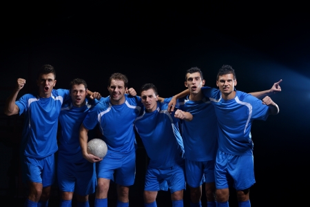 soccer players team group celebrating the victory and become champion of game while holding win coupの写真素材