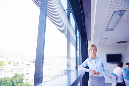 business woman  with her staff,  people group in background at modern bright office indoorsの写真素材