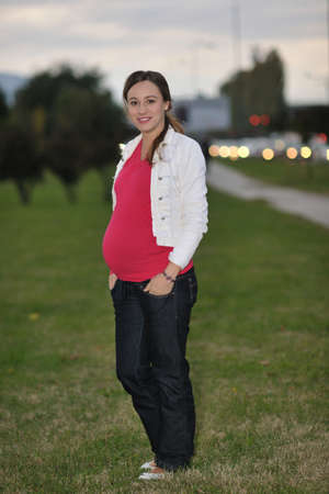 happy couple outdoor,  beautiful pregnant woman with her husbandの写真素材