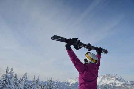 happy young ski woman at mountaint top on winter have funの写真素材