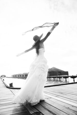 asian  bride with a veil on the beach in the sky and blue sea  honeymoon on the fantastic island at summerの写真素材