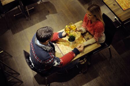 romantic evening date in restaurant  happy young couple with wine glass tea and cakeの写真素材