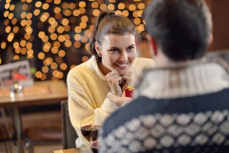 The young man gives a wedding ring   gift to  girl in restaurantの写真素材