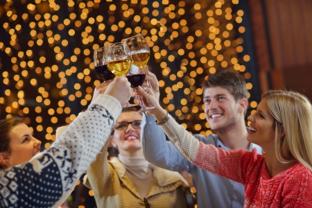 Group of happy young people drink wine at party disco restaurantの写真素材