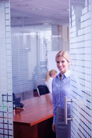 business woman  with her staff,  people group in background at modern bright office indoorsの写真素材