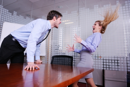 Angry business man screaming at employee in the officeの写真素材