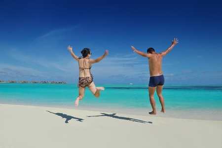 happy young asian couple have fun and romantic time at  summer on beautiful white sand beachの写真素材