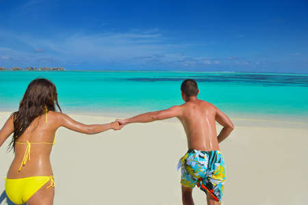 happy young asian couple have fun and romantic time at  summer on beautiful white sand beachの写真素材