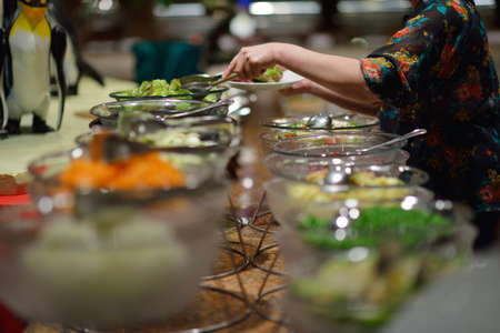 catering buffet food indoor in luxury restaurant with meat colorful fruits  and vegetablesの写真素材