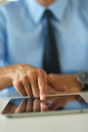 close-up of human hand  business man using tablet compuer at officeの写真素材