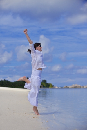 happy young woman on summer vacation on beautiful tropical beach have fun and relaxの写真素材