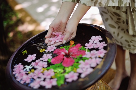 spa and beauty female hand and flower in water