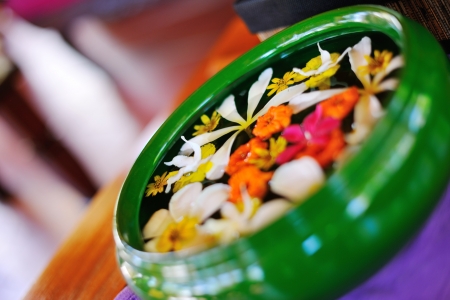 water cup with beautiful flowers, a variety of background colors in spa health and beauty centerの写真素材