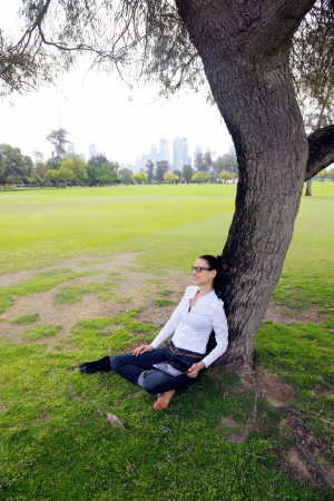 Beautiful young student  woman study with tablet in parkの写真素材
