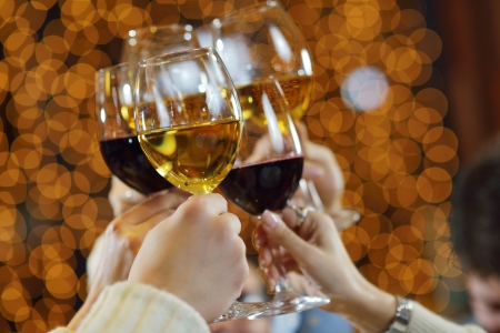 Celebration. Hands holding the glasses of champagne and wine making a toast.の写真素材