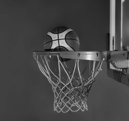 Basketball ball, board and net on black background in gym indoor