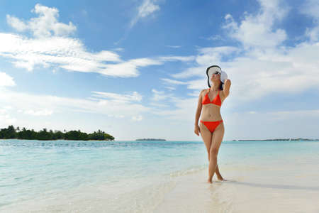 beautiful and happy woman girl on beach have fun and relax on summer vacation  over the seaの写真素材