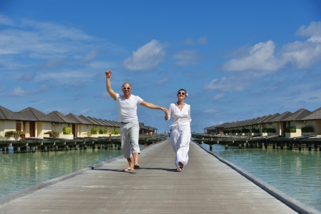 happy young romantic couple in love have fun running and relaxing on beautiful beachの写真素材