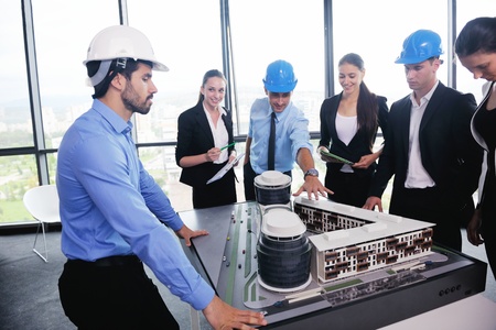 business people group on meeting and presentation  in bright modern office with construction...