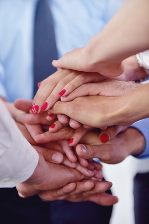 business people group joining hands and representing concept of friendship and teamwork,  low angle...