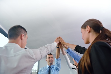 business people group joining hands and representing concept of friendship and teamwork,  low angle...