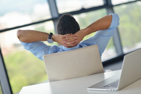 happy young business  man work in modern office on computerの写真素材