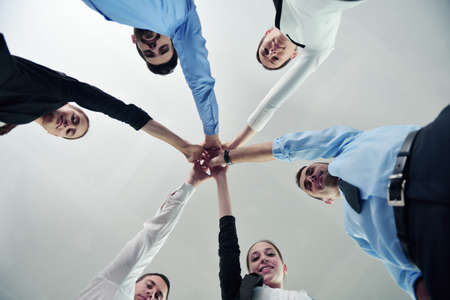business people group joining hands and representing concept of friendship and teamwork,  low angle viewの写真素材