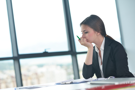 Portrait of tired young business woman at the officeの写真素材