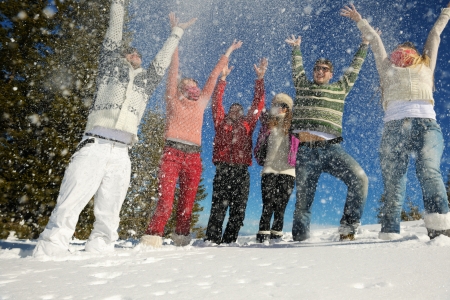 happy young people group have fun and enjoy fresh snow at beautiful winter dayの写真素材