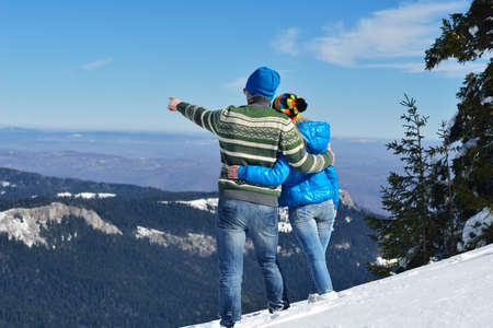 Young Couple In winter Snow Scene at  beautiful sunny dayの写真素材