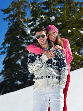 Young Couple In winter Snow Scene at  beautiful sunny dayの写真素材