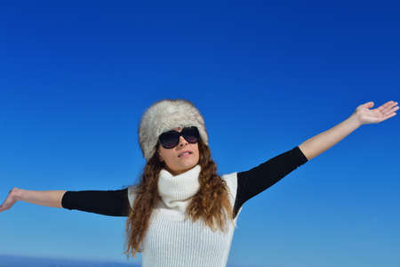 happy young woman having fun at winter nature landscape with fresh snowの写真素材
