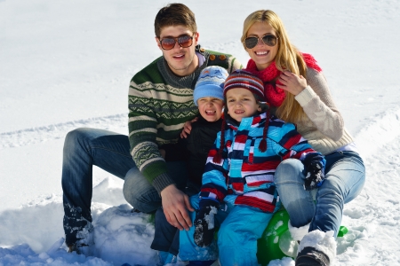 Winter season. Happy family having fun on fresh snow on vacation.の写真素材