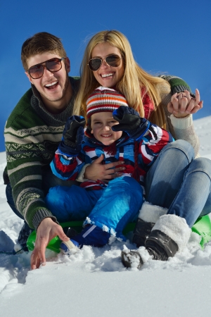 Winter season. Happy family having fun on fresh snow on vacation.の写真素材