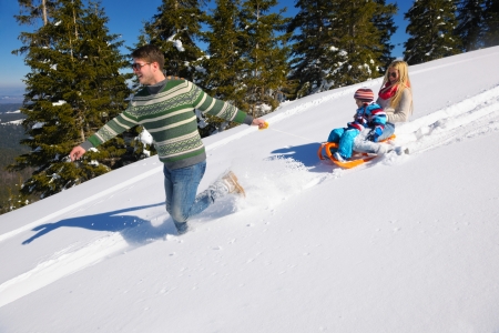 Winter season. Happy family having fun on fresh snow on vacation.の写真素材