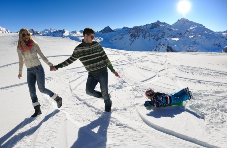 Winter season. Happy family having fun on fresh snow on vacation.の写真素材