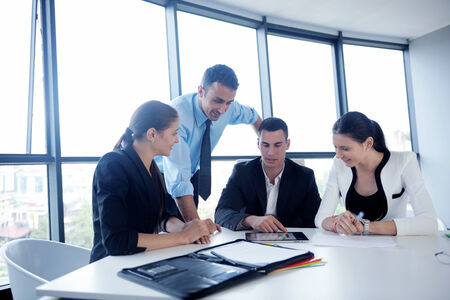 Group of happy young  business people in a meeting at officeの写真素材