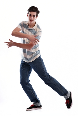 young boy man teen dancing and jumping isolated on white background in studioの写真素材