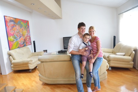 happy young family with kids in bright modern living room have fun and looking big flat lcd tvの写真素材
