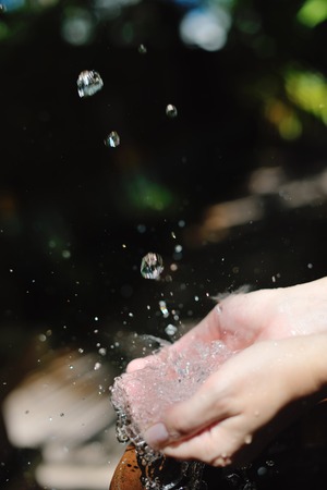 splashing fresh  water drops on girl soft skin  care for sensuality woman hands