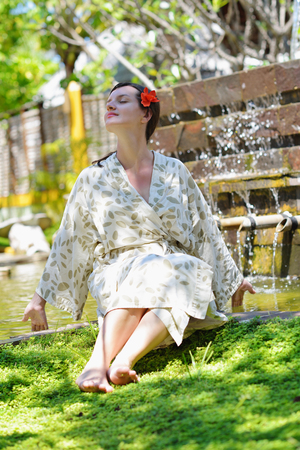 Woman getting spa treatment at tropical resortの写真素材