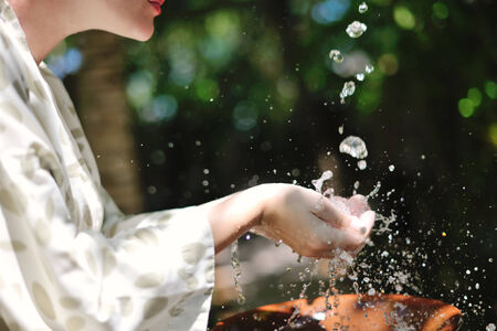 splashing fresh  water drops on girl soft skin  care for sensuality woman hands
