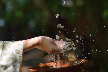 splashing fresh  water drops on girl soft skin  care for sensuality woman handsの写真素材
