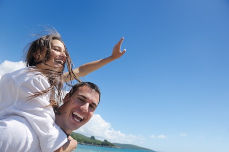 happy young couple have fun and relax  on the beachの写真素材