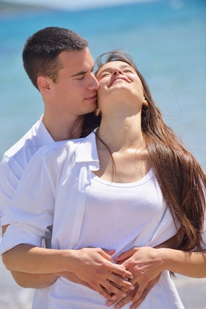 happy young couple have fun and relax  on the beach