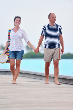 happy young romantic couple in love have fun running and relaxing on beautiful beachの写真素材
