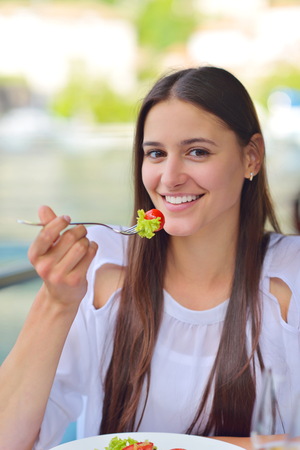 happy young couple having lanch at beautiful restaurant on by the sea on  beachの写真素材