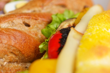 fresh sandwich close up with vegetables and meat fish isolated on white backgroundの写真素材