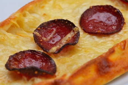 Homemade traditional Turkish meal pide stuffed with meat cheese,  and sauce isolated on white backgroundの写真素材