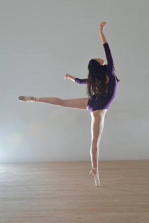 modern style ballet dancer posing and jumping on trainingの写真素材